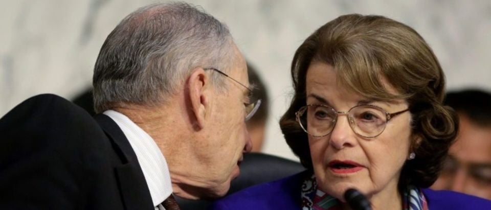 Senate Judiciary Committee Chairman Chuck Grassley (R-IA) speaks to Senator Dianne Feinstein (D-CA) as U.S. Attorney General Jeff Sessions (not pictured) testifies before a Senate Judiciary oversight hearing on the Justice Department on Capitol Hill in Washington, U.S., October 18, 2017. REUTERS/Joshua Roberts