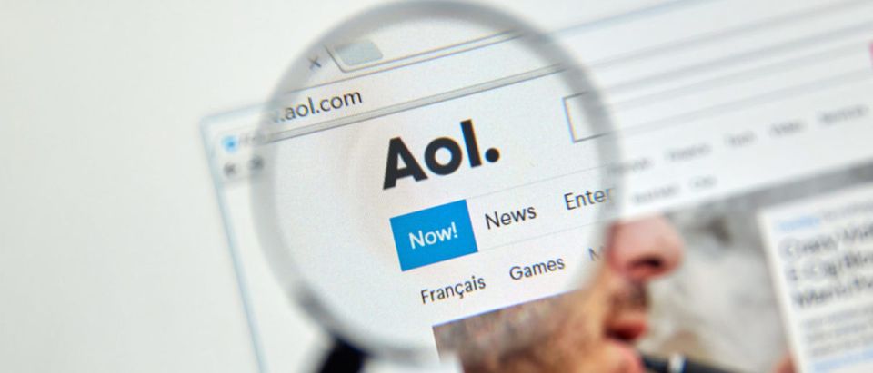 AOL mail and news on the web under magnifying glass. (Shutterstock - dennizn)