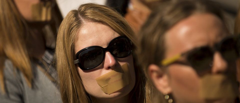 Journalists protest against censorship with taped mouths. [Shutterstock - Veselin Borishev]