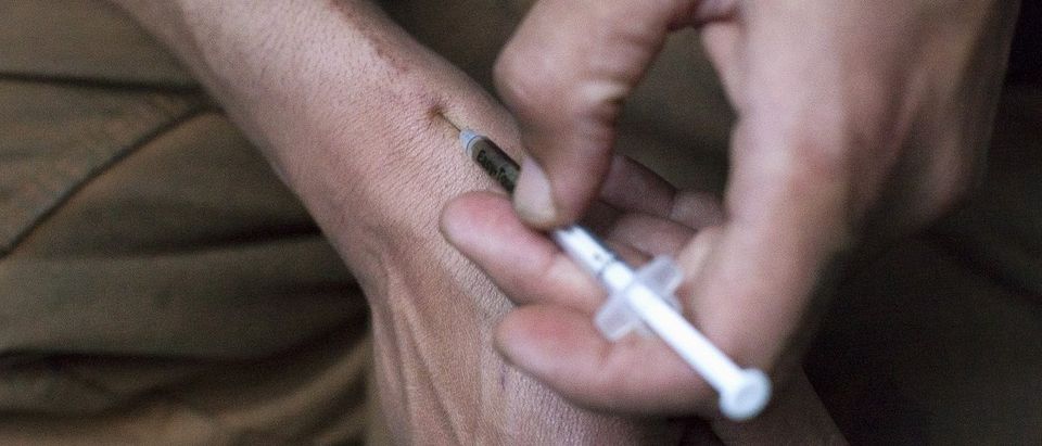 A man injects himself with heroin using a needle obtained from the People's Harm Reduction Alliance, the nation's largest needle-exchange program, in Seattle, Washington