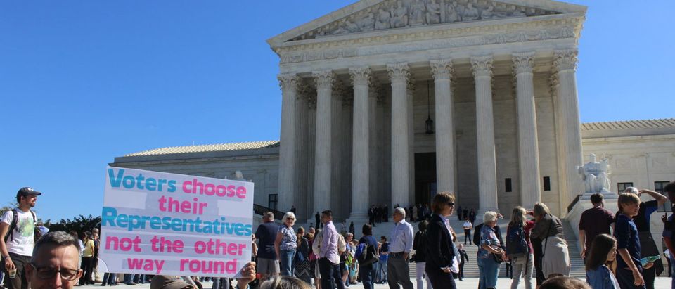 An activist protests partisan gerrymandering outside the Supreme Court in Oct. 2017. (Kevin Daley/TheDCNF)