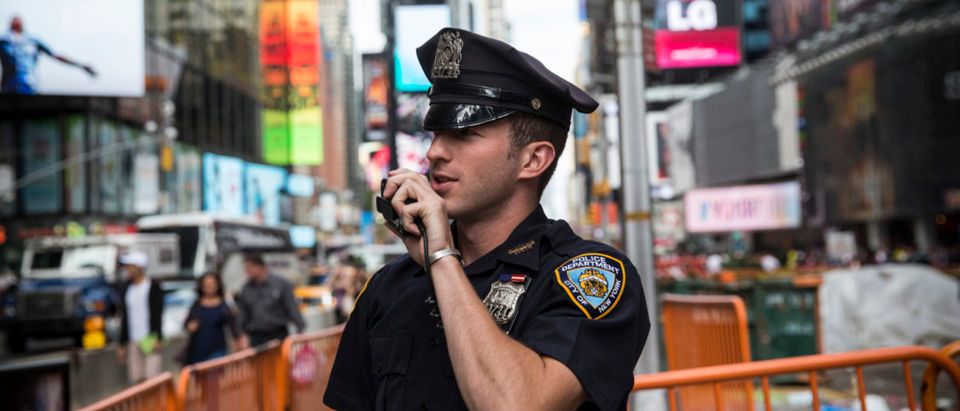 NEW YORK, NY - SEPTEMBER 22: A New York Police Department (NYPD) officer speaks on his radio in Times Square on September 22, 2013 in New York City. (Photo by Andrew Burton/Getty Images)