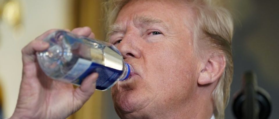 U.S. President Donald Trump drinks while speaking about his recent trip to Asia at the White House in Washington