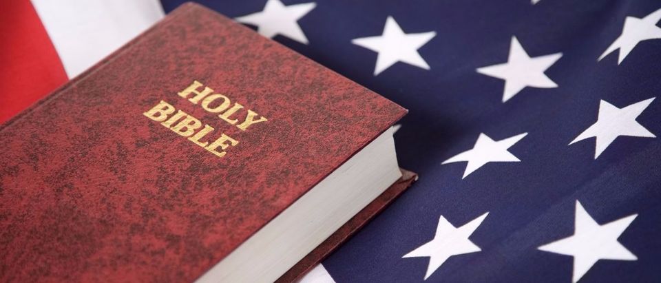 A Bible is on the USA flag. (Photo: Shutterstock/Mark Hayes)