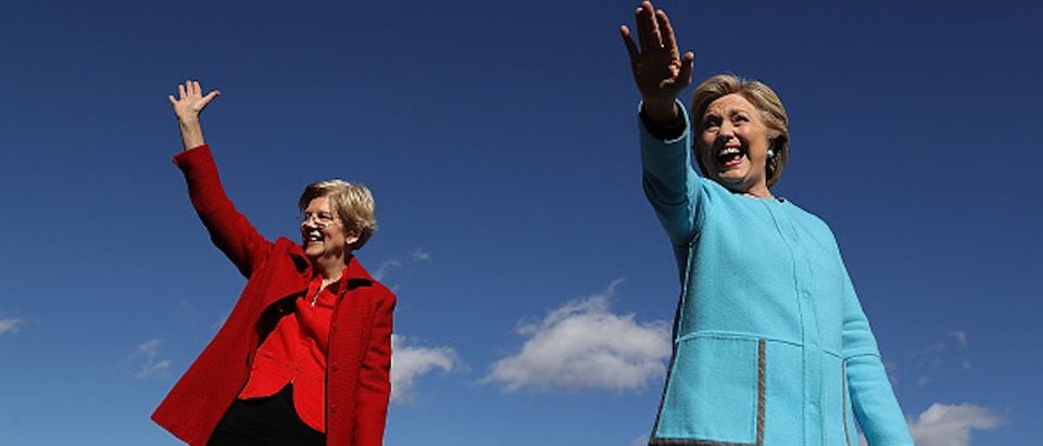 MANCHESTER, NH - OCTOBER 24: Democratic presidential nominee former Secretary of State Hillary Clinton (R) and U.S. Sen. Elizabeth Warren (D-MA) greet supporters during a campaign rally at Saint Anselm College on October 24, 2016 in Manchester, New Hampshire. With just over two weeks to go until the election, Hillary Clinton is campaigning in New Hampshire. (Photo by Justin Sullivan/Getty Images)