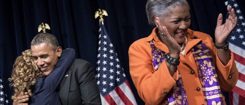 Donna Brazile (R) claps while US President Barack Obama (C) hugs Rep Debbie Wasserman Schultz (D-FL)before speaking to the Democratic National Committee at the Capital Hilton February 28, 2014 in Washington, DC. Obama spoke about the 2014 midterm elections. AFP (Photo: BRENDAN SMIALOWSKI/AFP/Getty Images)