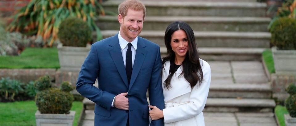 Britain's Prince Harry and his fiancée US actress Meghan Markle pose for a photographs in the Sunken Garden at Kensington Palace in London this morning following the announcement of their engagement. (Photo credit /DANIEL LEAL-OLIVAS/AFP/Getty Images)