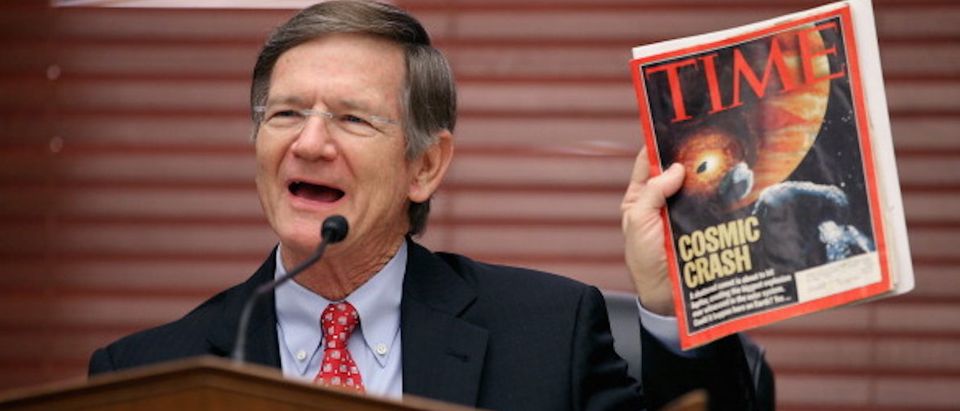 WASHINGTON, DC - MARCH 19: House Science, Space and Technology Committee Chairman Lamar Smith (R-TX) holds up a copy of TIME Magazine with a cover article about 'near-Earth objects' during a hearing in the Rayburn House Office Building on Capitol Hill March 19, 2013 in Washington, DC. The committee asked government and military experts about efforts to track and mitigate asteroids and meteors. (Photo by Chip Somodevilla/Getty Images)