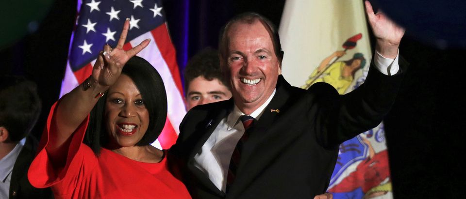 Phil Murphy, Governor-elect of New Jersey, and Shiela Oliver, Lieutenant Governor-elect, wave to supporters at their election night victory rally in Asbury Park, New Jersey
