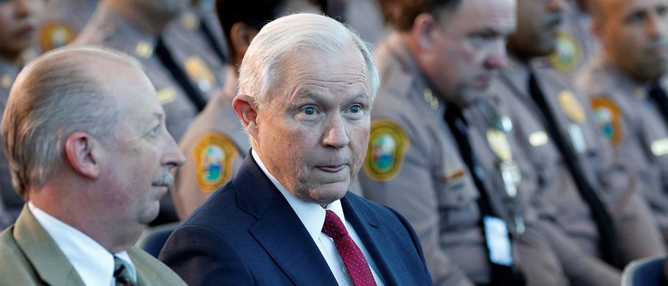 U.S. Attorney General Sessions sits with guests before speaking on the growing trend of violent crime in sanctuary cities during an event on the Port of Miami in Miami