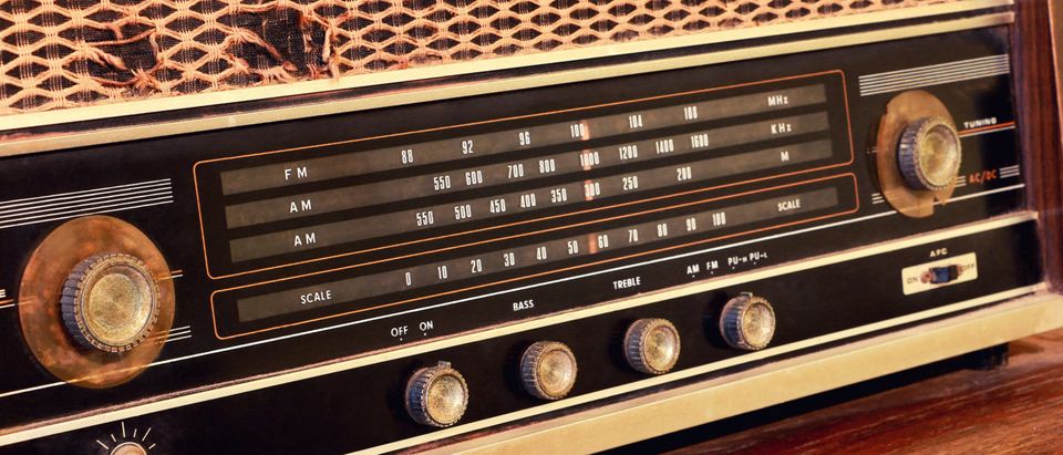 This is a close-up of vintage radio buttons and a tuner control panel (Shutterstock/MBR9292)