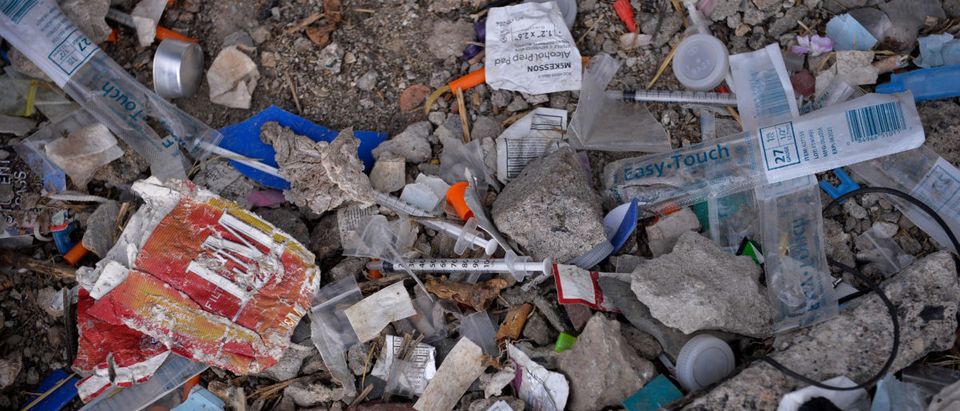Needles used for shooting heroin and other opioids along with other paraphernalia litter the ground in a park in the Kensington section of Philadelphia, Pennsylvania, U.S. October 26, 2017. REUTERS/Charles Mostoller