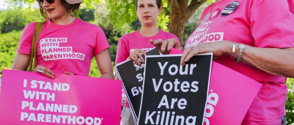 Supporters of Planned Parenthood hold signs during a rally to fight back against the U.S. House of Representatives' vote to repeal the Affordable Care Act held outside of the office of Congressman Steve Knight in Santa Clarita, Los Angeles, California, U.S., May 4, 2017. REUTERS/Andrew Cullen