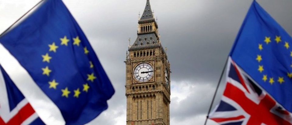FILE PHOTO: Union Flags and European Union flags fly near the Elizabeth Tower, housing the Big Ben bell, during the anti-Brexit 'People's March for Europe', in Parliament Square in central London