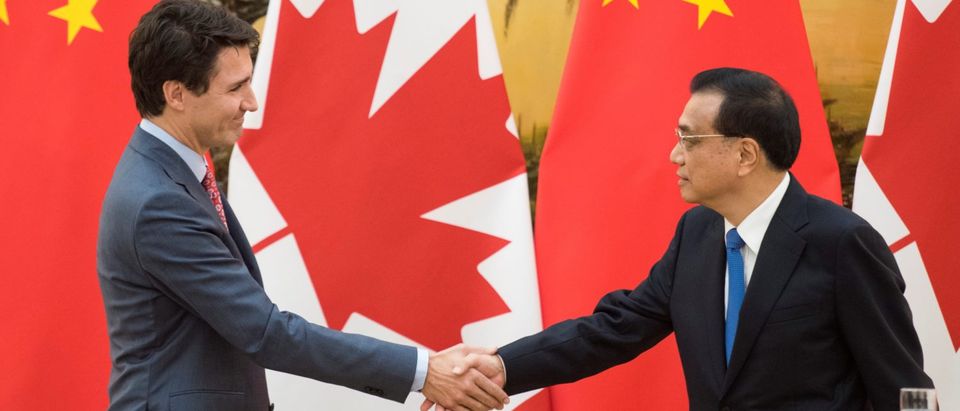 Canadian Prime Minister Justin Trudeau and Chinese Premier Li Keqiang shake hands during a news conference meeting at the Great Hall of the People in Beijing
