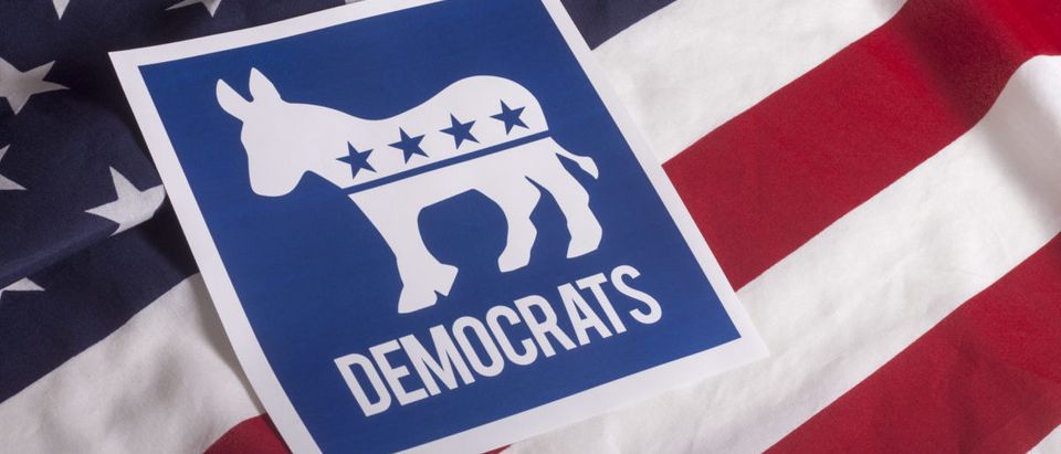 A Democratic symbol is on a textured American flag. (Photo: ShutterStock/Danielfela)