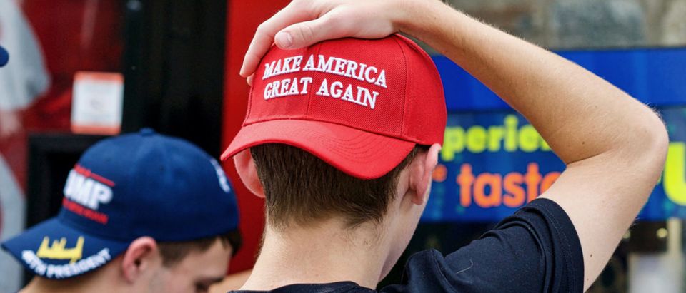 Two unidentified men display their support for President Donald J. Trump through the hats they are wearing during a visit to the National Zoo. (Shutterstock/John M. Chase)