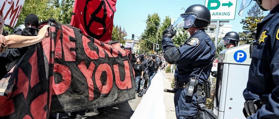 Riot police stand before Antifa members and counter protesters during a rightwing No To Marxism rally on August 27, 2017 at Martin Luther King Jr. Park in Berkeley, California. (Photo: Amy Osborne/AFP/Getty Images)