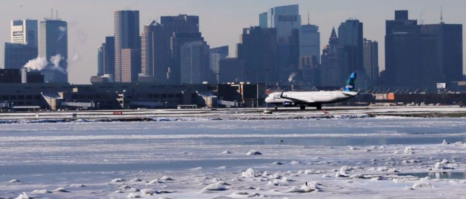 FILE PHOTO: Ahead of an incoming winter snow storm, a Jet Blue flight waits to take off from Logan International Airport next to the frozen waters of the Atlantic Ocean harbour between Winthrop and Boston, Massachusetts, U.S., January 3, 2018. REUTERS/Brian Snyder
