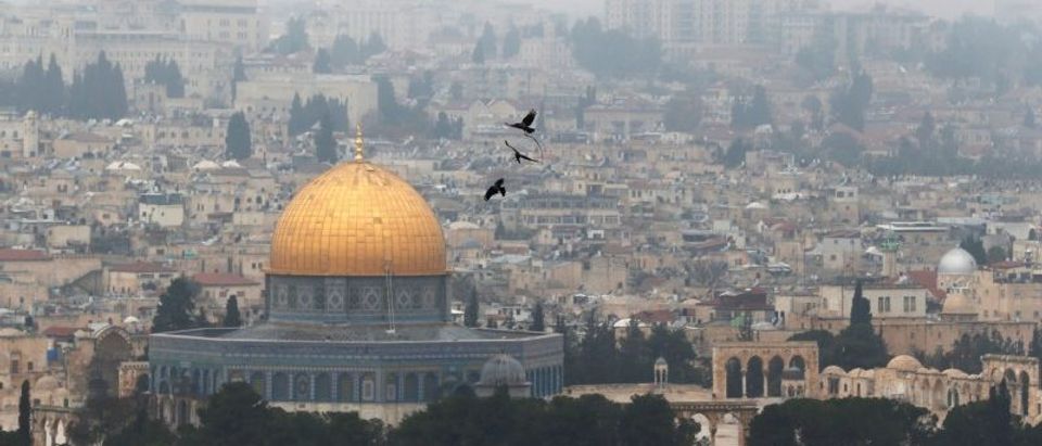 Birds fly on a foggy day near the Dome of the Rock, located in Jerusalem's Old City on the compound known to Muslims as Noble Sanctuary and to Jews as Temple Mount