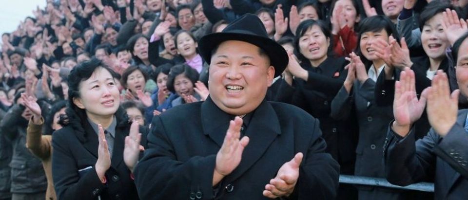 North Korean leader Kim Jong Un reacts as people applaud during his visit to the newly-remodeled Pyongyang Teacher Training College