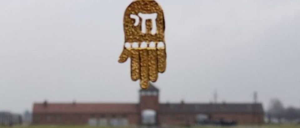 Picture of Jewish necklace touching Birkenau gate Sam Barak via Facebook
