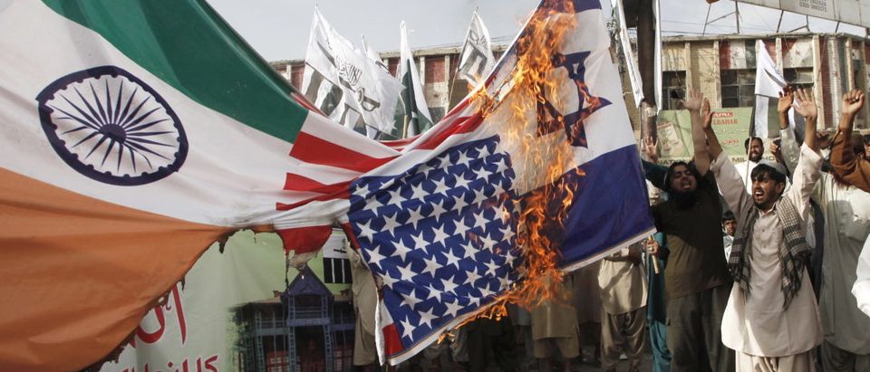 Pakistani activists burn Indian, U.S. and Israeli flags at a rally in Quetta, Pakistan, August 14, 2015. REUTERS/Naseer Ahmed