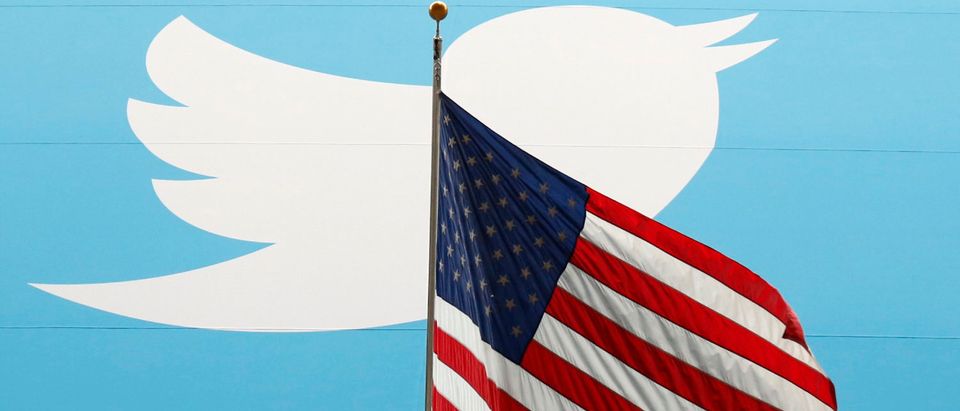 The Twitter Inc. logo is shown with the U.S. flag during the company's IPO on the floor of the New York Stock Exchange in New York, November 7, 2013. REUTERS/Lucas Jackson/File Photo