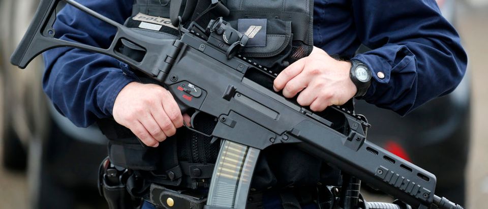 A policeman holds a HKG36 assault rifle as he secures the position in front of the city hall after two assailants had taken five people hostage in the church at Saint-Etienne-du-Rouvray near Rouen in Normandy, France, July 26, 2016. Two attackers killed a priest with a blade and seriously wounded another hostage in a church in northern France on Tuesday before being shot dead by French police. REUTERS/Pascal Rossignol