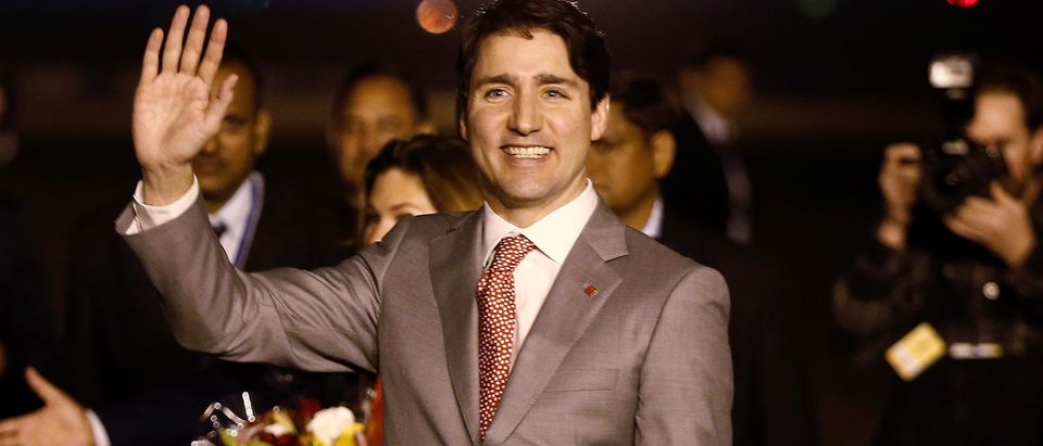 Canadian Prime Minister Justin Trudeau waves towards the media upon his arrival at Air Force Station Palam in New Delhi