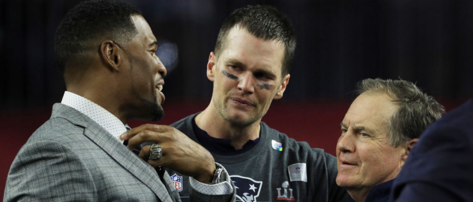 HOUSTON, TX - FEBRUARY 05: Michael Strahan, Tom Brady #12 and head coach Bill Belichick of the New England Patriots reacts after defeating the Atlanta Falcons 34-28 in overtime during Super Bowl 51 at NRG Stadium on February 5, 2017 in Houston, Texas. (Photo by Mike Ehrmann/Getty Images)