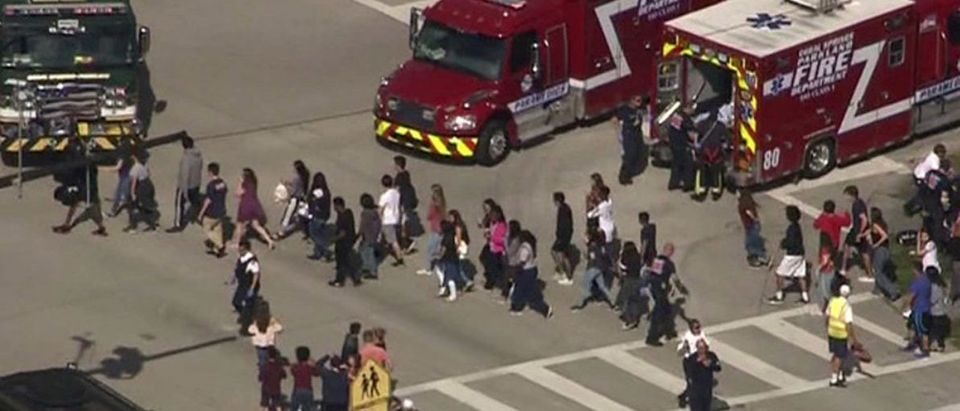 Students are evacuated from Marjory Stoneman Douglas High School during a shooting incident in Parkland, Florida, U.S. February 14, 2018 in a still image from video. WSVN.com via REUTERS.