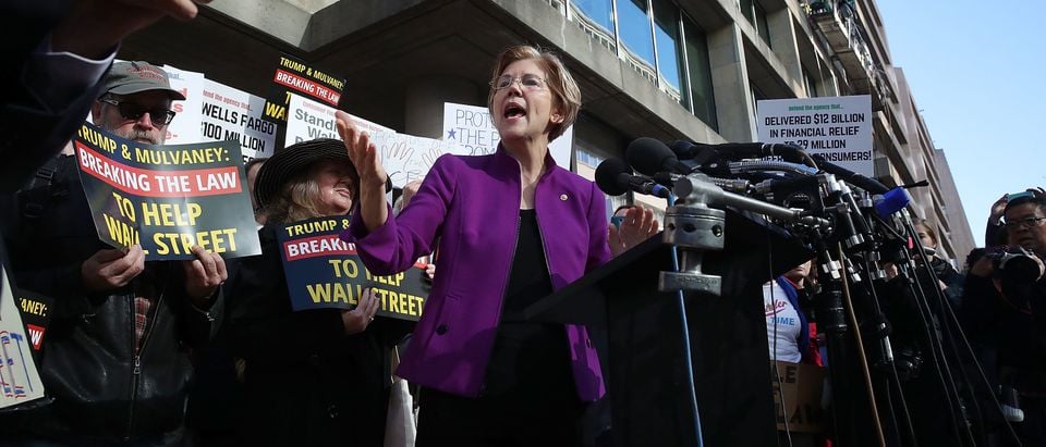 WASHINGTON, DC - NOVEMBER 28: Sen. Elizabeth Warren (D-MA) speaks during a protest in front of the Consumer Financial Protection Bureau (CFPB) headquarters on November 28, 2017 in Washington, DC. Sen. Warren is demanding that Mick Mulvaney step aside and let acting CFPB director Leandra English do her job. President Trump named Office of Management and Budget (OMB) Director Mick Mulvaney to replace outgoing CFPB Director Richard Cordray. (Photo by Mark Wilson/Getty Images)