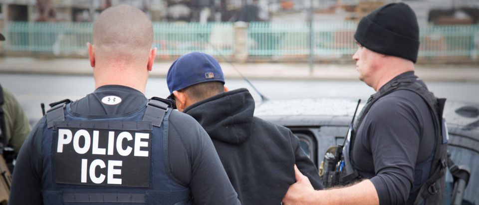 ICE officers detain a suspect as they conduct a targeted enforcement operation in Los Angeles