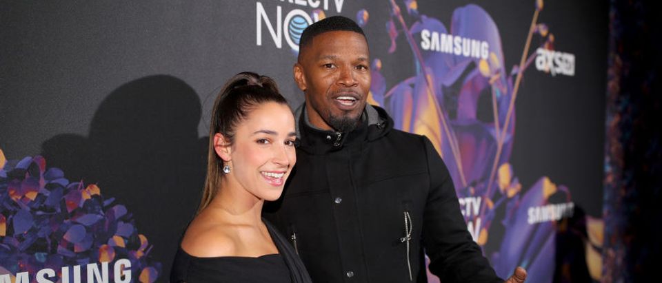 Olympic gymnast Aly Raisman (L) and actor Jamie Foxx attend the 2018 DIRECTV NOW Super Saturday Night Concert at NOMADIC LIVE! at The Armory on February 3, 2018 in Minneapolis, Minnesota. (Photo by Christopher Polk/Getty Images for DirecTV)