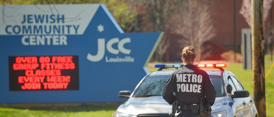 A police officer blocks an entrance as officials respond to a bomb threat at the Jewish Community Center in Louisville