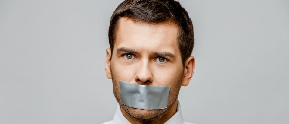 A professor is literally censored with a piece of tape. (Shutterstock/Anatolii Riepin)