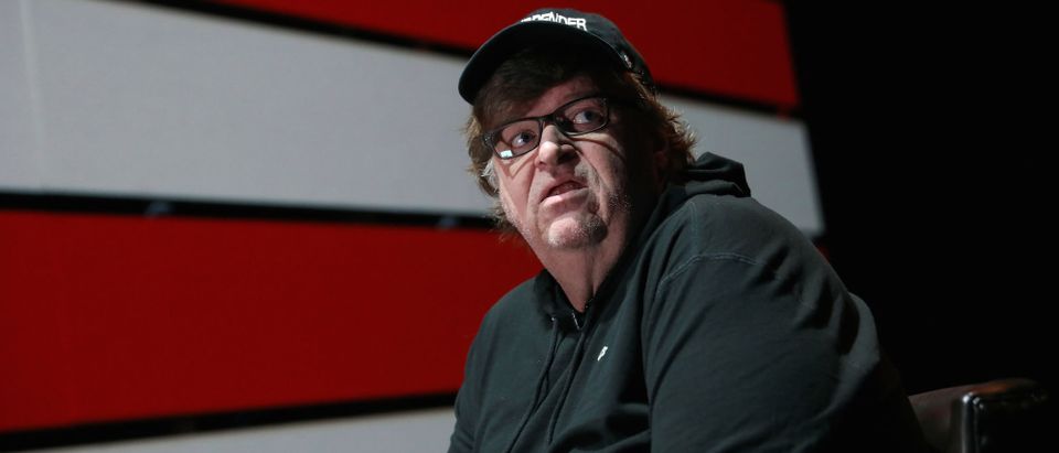 Michael Moore looks off stage during an interview at the site of his one-man Broadway show at the Belasco Theatre in Manhattan, New York