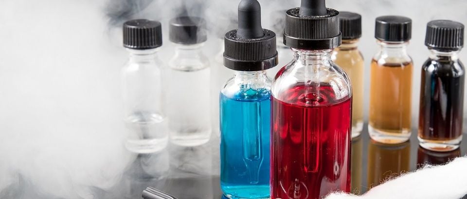 Vaporizer smoke with juice bottles, screwdriver and cotton wick with tools. (Rain Ungert/Shutterstock)
