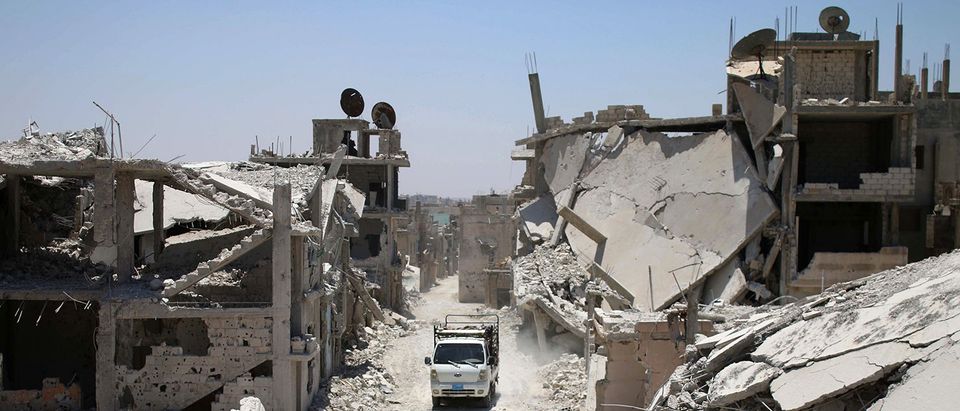 A truck drives down a destroyed street in a rebel-held area in Daraa on July 19, 2017, as civilians started to return to the area following the July 9 agreement ceasefire brokered by the United States, Russia and Jordan creating a de-escalation zone in Syria's southern Daraa, Quneitra and Sweida regions. MOHAMAD ABAZEED/AFP/Getty Images