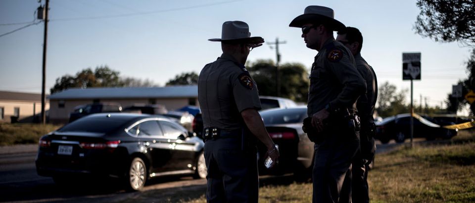 Members of the Wilson County Sheriff's office stand just inside taped off area near the First Baptist Church where a shooting left many dead and injured in Sutherland Springs, Texas, U.S., November 5, 2017. REUTERS/Sergio Flores