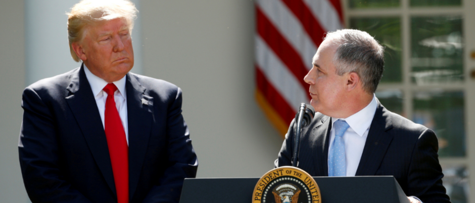 FILE PHOTO: U.S. President Donald Trump listens to EPA Administrator Scott Pruitt after announcing his decision that the United States will withdraw from the Paris Climate Agreement, in the Rose Garden of the White House in Washington, U.S., June 1, 2017. REUTERS/Kevin Lamarque/File Photo