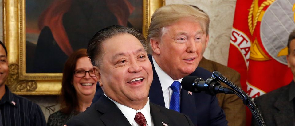 President Donald Trump hugs Broadcom CEO Hock Tan as Tan announces the repatriation of his company's headquarters to the United States from Singapore during a ceremony in the Oval Office of the White House on November 2, 2017. | Photo: Martin H. Simon - Pool/Getty Images
