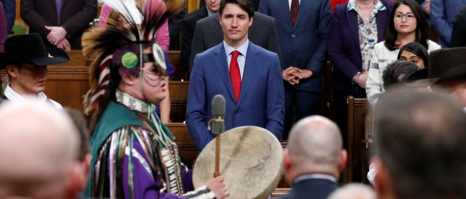 Canada's PM Trudeau listens to a drummer after delivering a statement of exoneration to the Tsilhqot'in Nation in the House of Commons in Ottawa