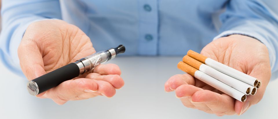 Close-up Of Businessperson Holding Electronic Cigarette In Hand. (Shutterstock)
