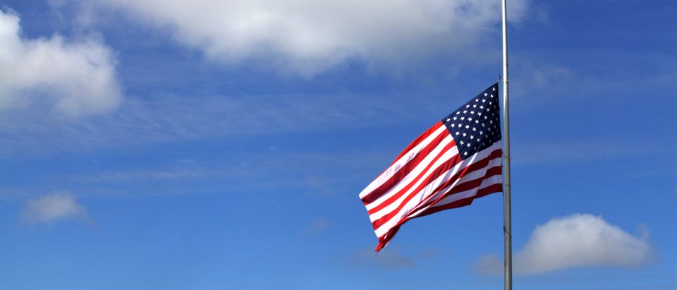The American flag at half mast. Shutterstock)