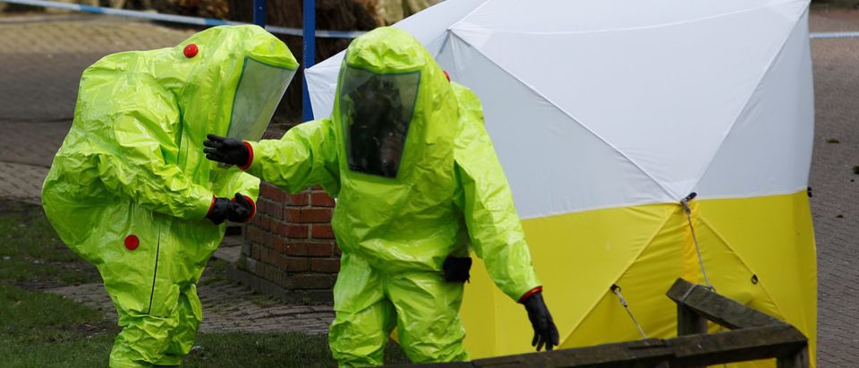 The forensic tent, covering the bench where Sergei Skripal and his daughter Yulia were found, is repositioned by officials in protective suits in the centre of Salisbury