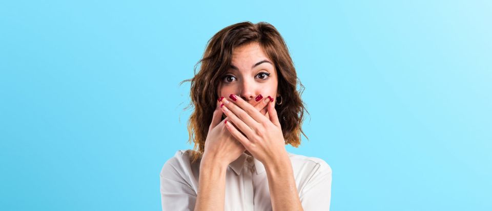 This woman is very shocked. (Shutterstock/Luis Molinero) | Teacher Suspended After Saying N-Word