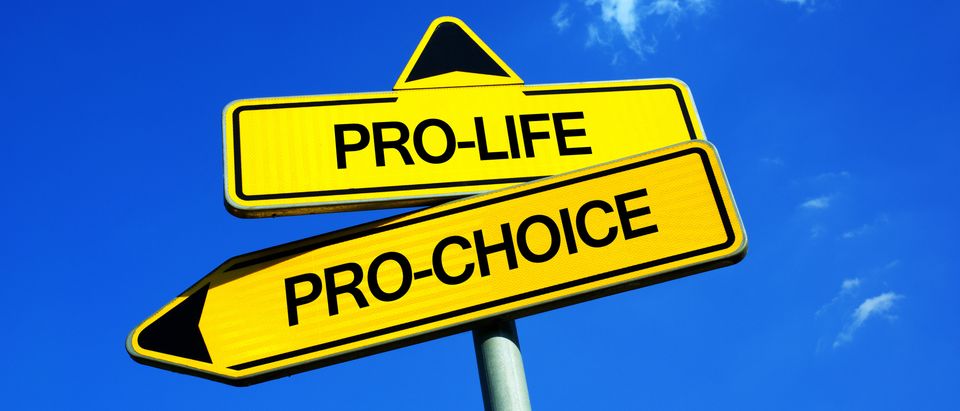 Traffic sign with two options (Shutterstock/M-SUR) | Catholic OB-GYN Explains Why She Aborted