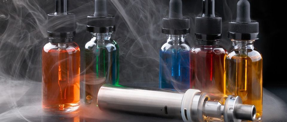 Electronic cigarette and vape liquids within vapor on black background. (MakcouD/Shutterstock) | Blu Criticizes 'WHO's Silence On Vaping'